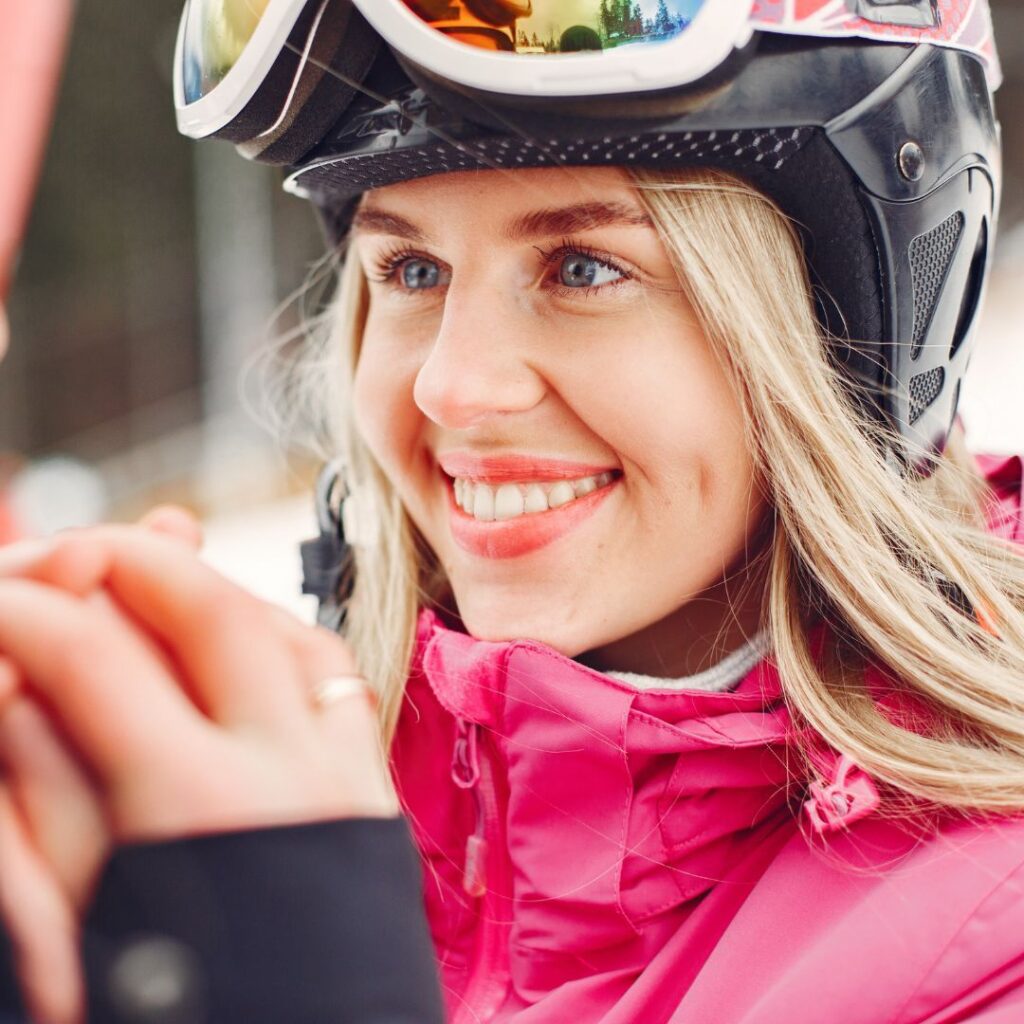 don't skip sunscreen- woman in ski helmet and pink jacket