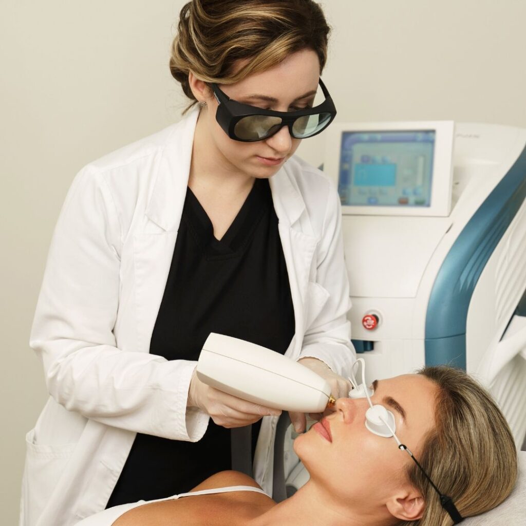 IPL Technology - doctor with large dark protective glasses applying IPL treatment