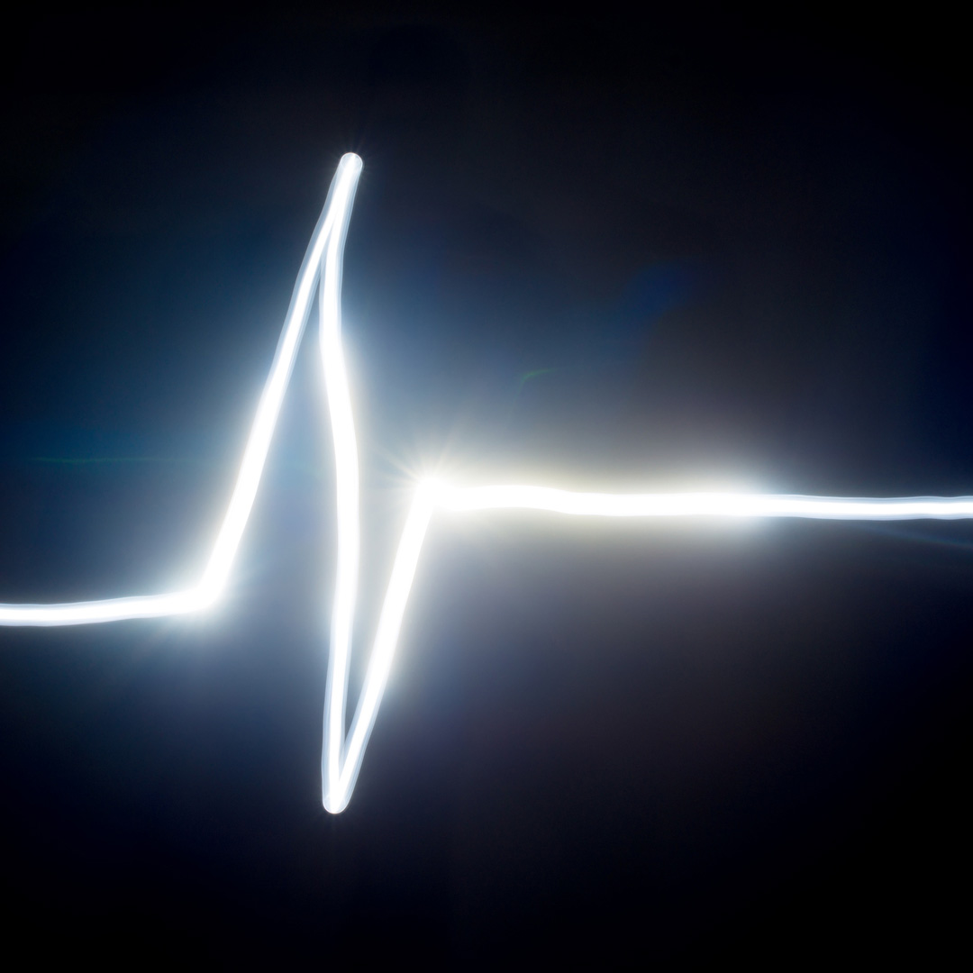 IPL Intense Pulsed LIght treatment - showing glowing pulse of white on dark blue background